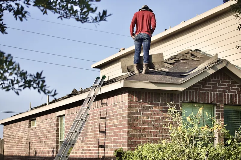 Professional roofer working on a residential roof in Golconda